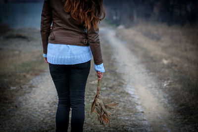 Woman holding wildflower