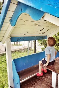 Rear view of boy sitting in car