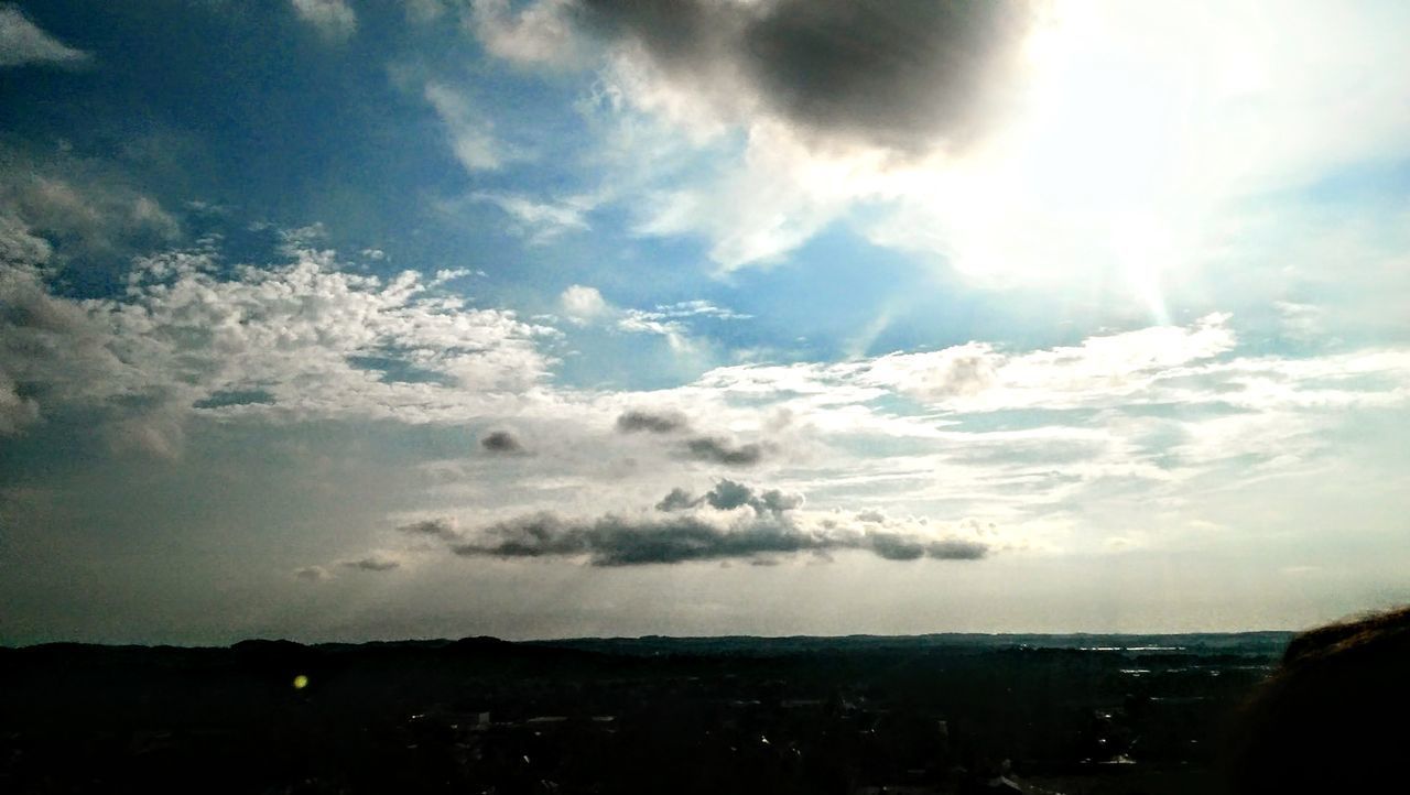 SCENIC VIEW OF SKY OVER SILHOUETTE LANDSCAPE AGAINST BRIGHT SUN