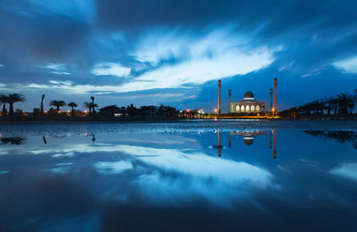 Panoramic view of factory against blue sky at dusk