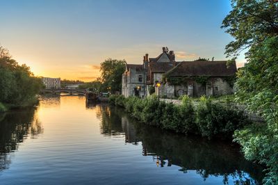 Archbishops residence over river by buildings against sky