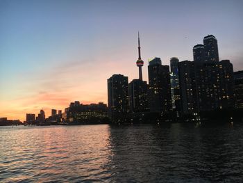 Buildings in city at sunset