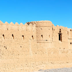 Low angle view of building against clear blue sky