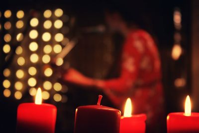 Close-up of lit candles in temple