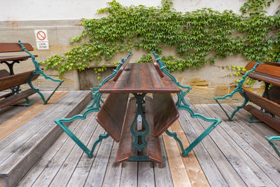 Empty chairs and table against trees