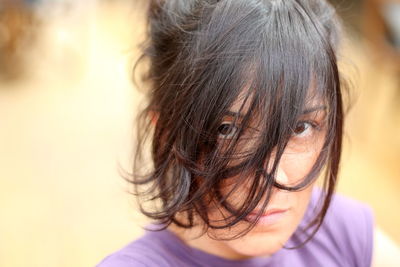 Close-up portrait of mature woman with tousled hair