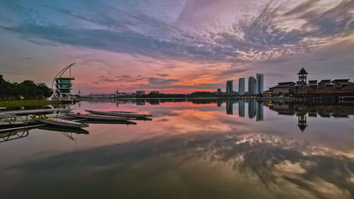 Reflection of buildings in city during sunset