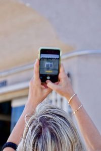 Midsection of woman photographing with mobile phone