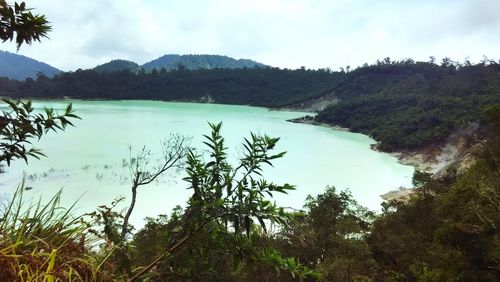 Scenic view of lake and mountains against sky