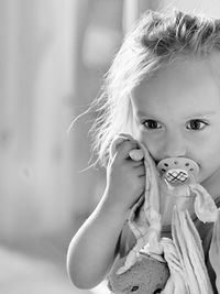 Close-up portrait of cute girl holding camera