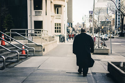 Rear view of woman walking in city