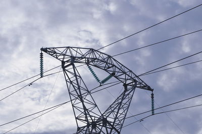 Low angle view of electricity pylon against sky