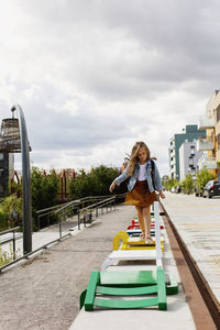 Girl waling on benches