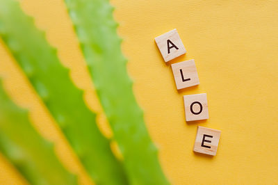 Close-up of yellow toy against wall