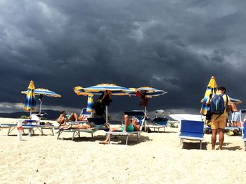 Scenic view of beach against cloudy sky