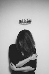 Young woman looking away over white background