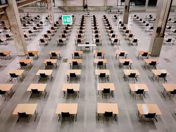 High angle view of empty chairs and tables arranged in building