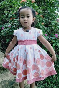 Portrait of a girl standing on field