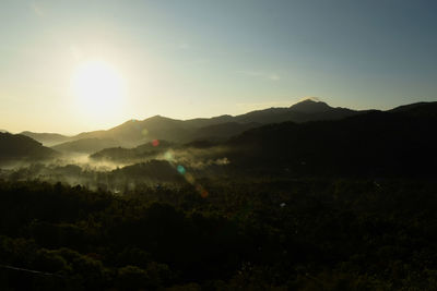 Scenic view of silhouette mountains against sky at sunset