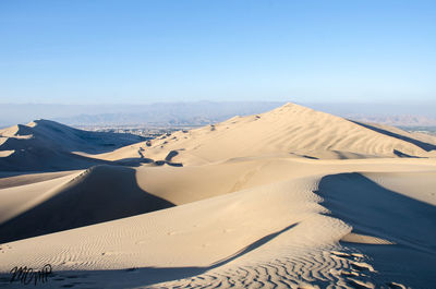 Scenic view of desert against clear sky