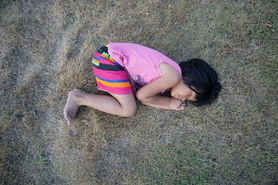 High angle view of girl lying on land