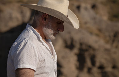 Adult man in cowboy hat in desert. almeria, spain