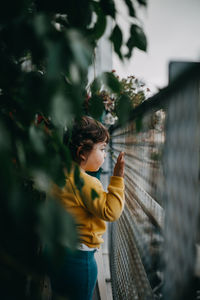 Little girl looking from balcony