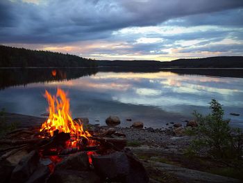 View of bonfire against sky at sunset