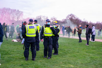 Rear view of people standing in park