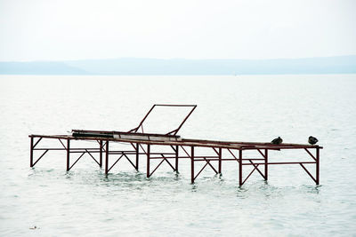 Lifeguard hut on sea against clear sky