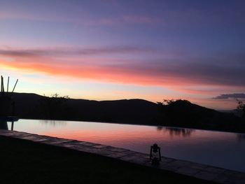 Scenic view of lake against orange sky