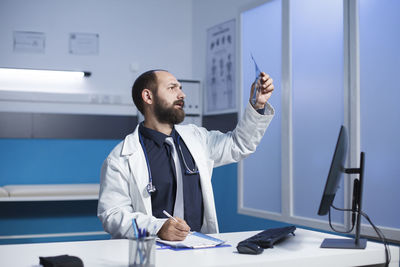 Portrait of young woman standing in laboratory