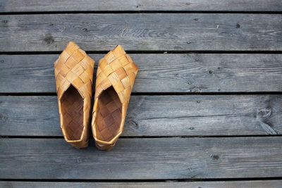 Directly above shot of bamboo shoes on wooden table