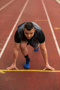 Full length of man on running track