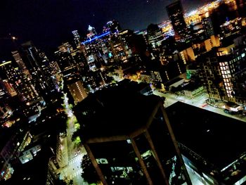 High angle view of illuminated buildings in city at night