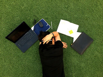 High angle view of man using mobile phone on field