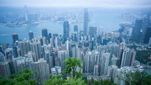 High angle view of modern buildings in city against sky