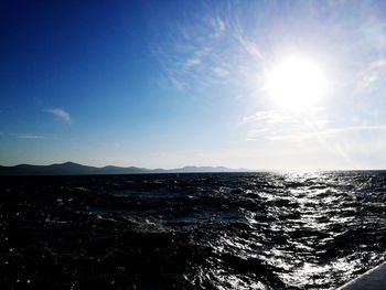 Scenic view of sea against sky on sunny day