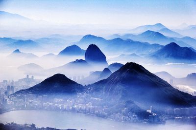 Scenic view of mountains against blue sky