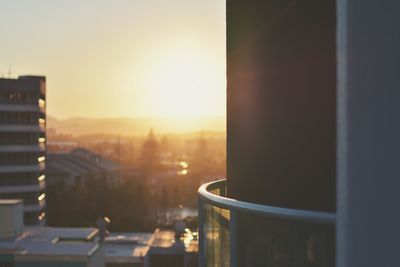 Close-up of cityscape against sky during sunset