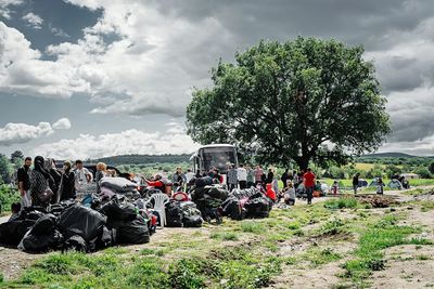 View of field against cloudy sky