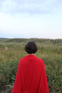 Rear view of woman looking at field