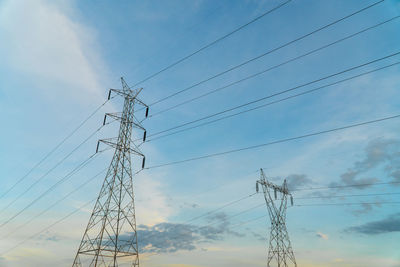 Low angle view of electricity pylon against sky