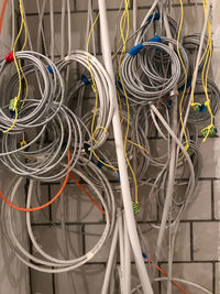 Close-up of cables hanging against wall