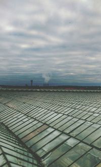 View of calm sea against cloudy sky