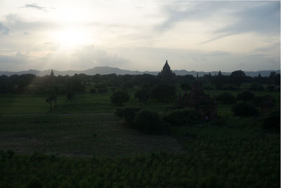 Panoramic view of temple on field against sky