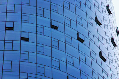 Low angle view of modern glass building in city