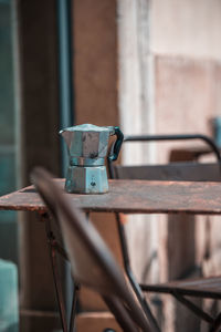 Close-up of metallic container on table