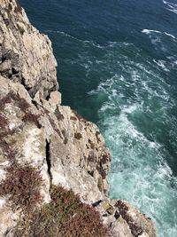 High angle view of rocks on sea shore