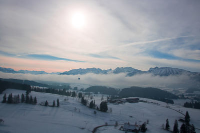 Scenic view of snowcapped mountains against sky during sunset